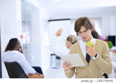 Portrait of confident businessman using digital 28479946