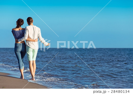 Couple walking on beach. Young happy interracial Couple walking on beach. Young happy interracial 28480134