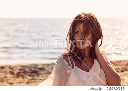 Young female enjoying sunny day on tropical beach Young female enjoying sunny day on tropical beach 28480336