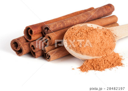 a stack of cinnamon sticks and powder with spoon a stack of cinnamon sticks and powder with spoon 28482197