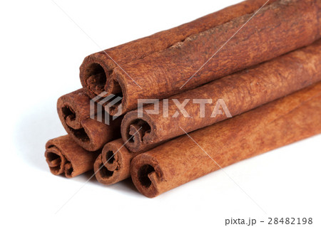 a stack of cinnamon sticks isolated on white 28482198