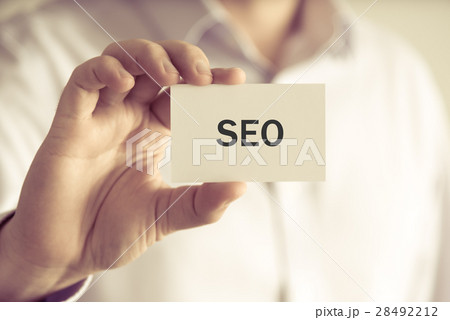 Businessman holding SEO message card 28492212