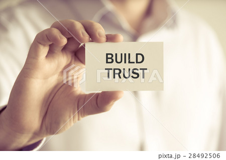 Businessman holding BUILD TRUST message card Businessman holding BUILD TRUST message card 28492506