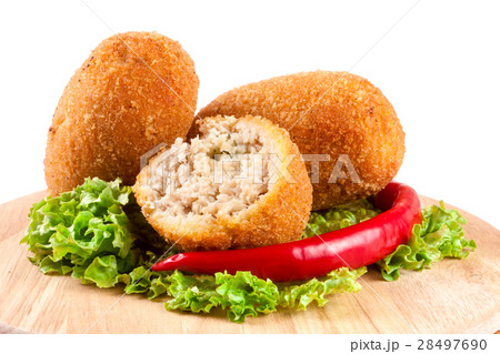 three fried breaded cutlet with lettuce on a three fried breaded cutlet with lettuce on a 28497690