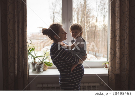young pregnant mother and son playing, hugging young pregnant mother and son playing, hugging 28498463