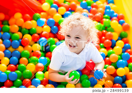 Child playing in ball pit on indoor playground 28499139