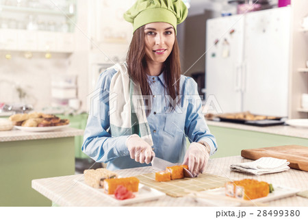Female cook wearing Chef s hat and gloves making Female cook wearing Chef s hat and gloves making 28499380