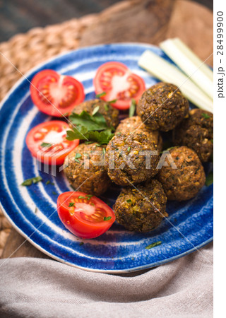 Falafel with tomato and celery on a blue plate 28499900