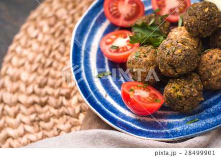 Falafel with tomato and celery on a blue plate Falafel with tomato and celery on a blue plate 28499901