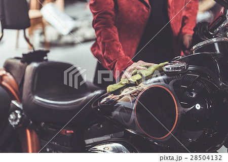 Granny rubbing bike in mechanic shop Granny rubbing bike in mechanic shop 28504132