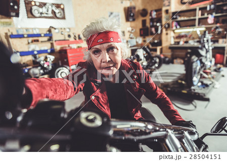 Calm old woman riding bike 28504151