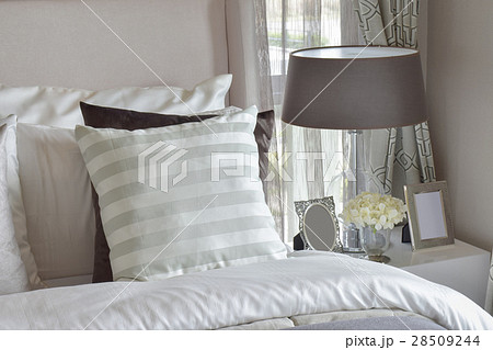 modern bedroom with green striped pillow on bed 28509244