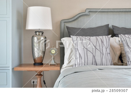 Silver table lamp with clock and classic bedding 28509307
