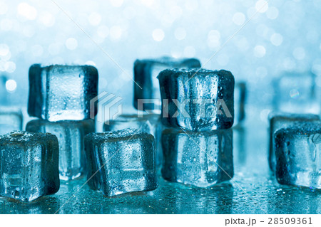 Melting ice cubes on glass table 28509361