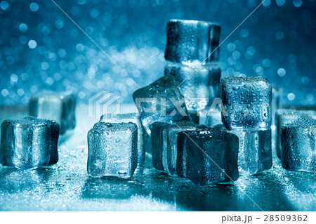 Melting ice cubes on glass table 28509362
