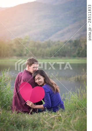 Loving couple. Beautiful young love couple holding paper hearts 28511833