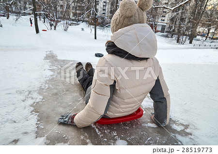 Girl sitting in plastic sledge on isy hill 28519773