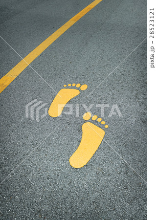 Foot sign on asphalt road 28523121