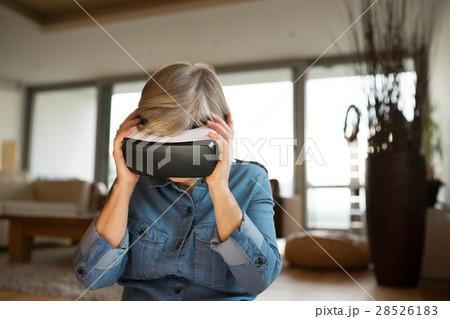 Senior woman wearing virtual reality goggles at Senior woman wearing virtual reality goggles at 28526183