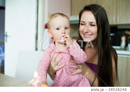 Mother with her cute daughter eating her birthday 28526240