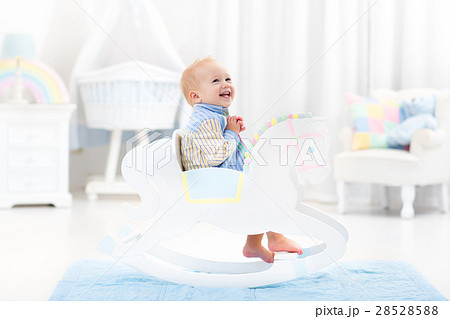 Baby boy in rocking horse toy 28528588