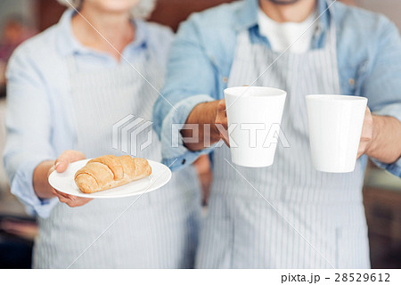 Pleasant hospitable waiters welcoming guests Pleasant hospitable waiters welcoming guests 28529612