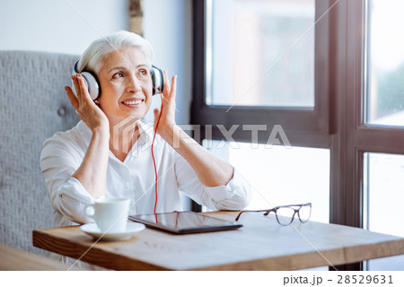 Positive aged woman resting in the cafe Positive aged woman resting in the cafe 28529631