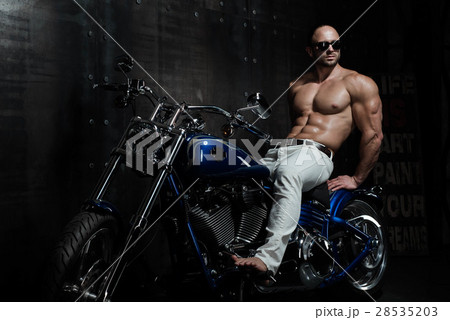 Hot sexy handsome young bodybuilder on a motorbike Hot sexy handsome young bodybuilder on a motorbike 28535203