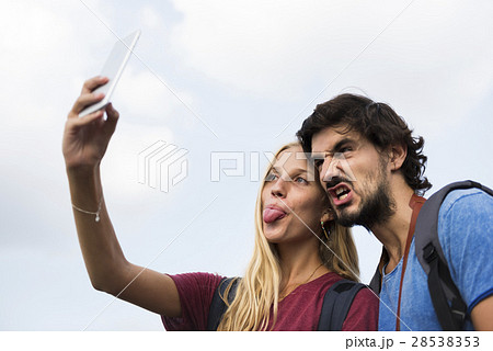 Couple taking a wacky selfie tongue out 28538353