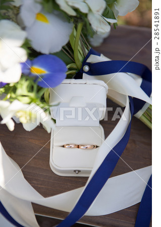 Wedding rings and white blue flower bouquet 28541891