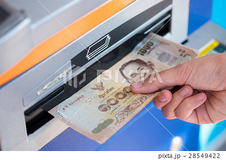 woman hand picking Thai Baht banknotes from ATM woman hand picking Thai Baht banknotes from ATM 28549422