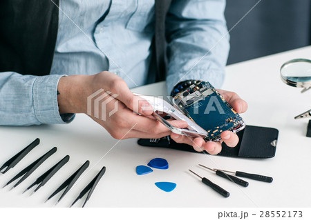 Disassembled smartphone on repairman workplace 28552173