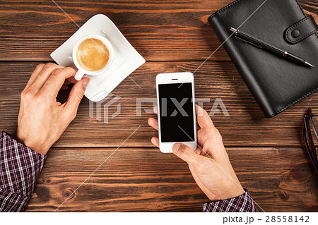 Male hands holding a smartphone 28558142
