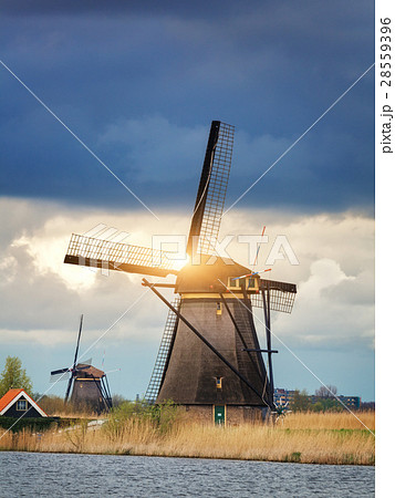 Windmills against cloudy sky at sunset 28559396