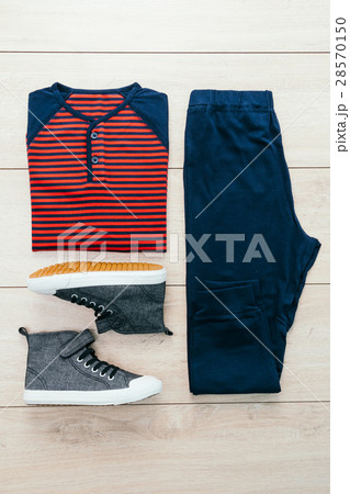 T-shirt with pants and shoes on wooden background T-shirt with pants and shoes on wooden background 28570150