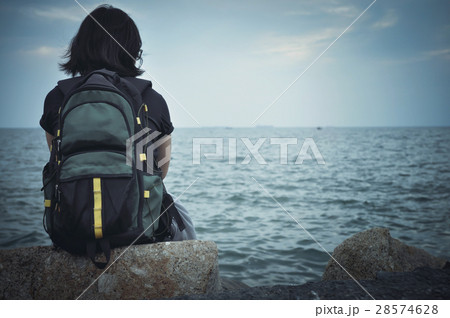 Woman traveller sitting on rock for resting. 28574628