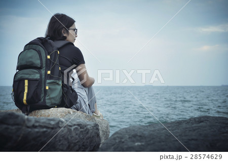Woman traveller sitting on rock for resting. Woman traveller sitting on rock for resting. 28574629