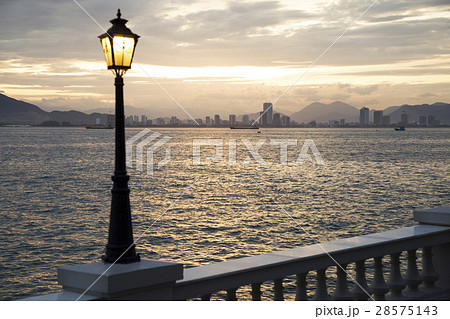 Sunset on the beach with views of the city 28575143