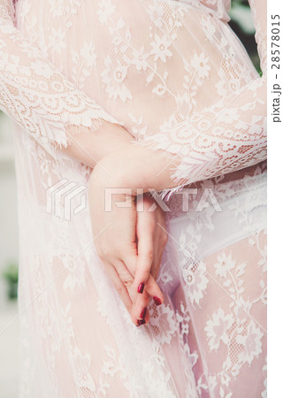 Beautiful bride's hands in white negligee. Beauty 28578015