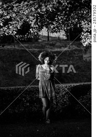 Young black woman with afro hairstyle smiling in urban backgroun Young black woman with afro hairstyle smiling in urban backgroun 28579502