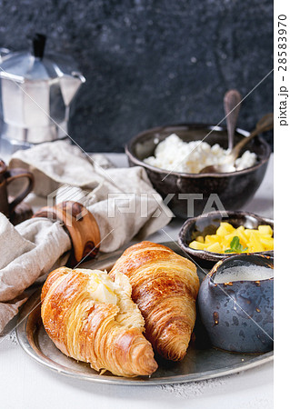 Breakfast with croissant and mango fruit Breakfast with croissant and mango fruit 28583970
