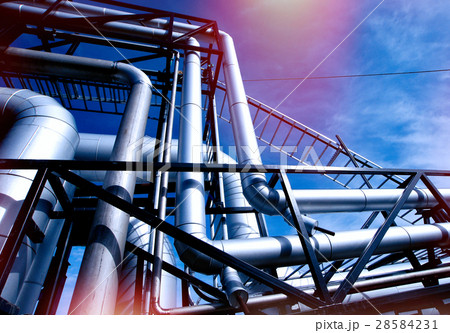 Steel pipelines and valves against blue sky 28584231