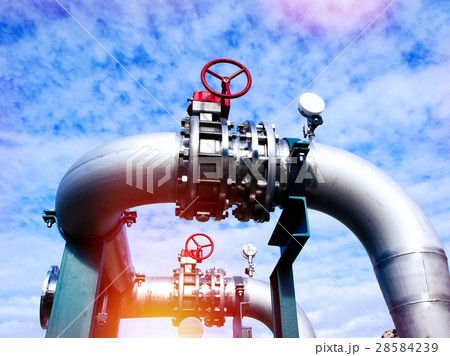 Steel pipelines and valves against blue sky 28584239