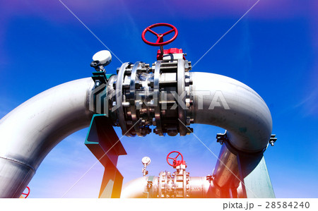 Steel pipelines and valves against blue sky 28584240