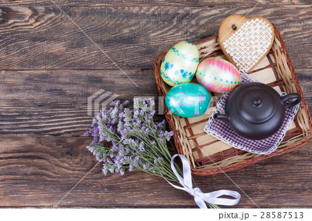 Easter Eggs with flowers and tea pot on wood Easter Eggs with flowers and tea pot on wood 28587513