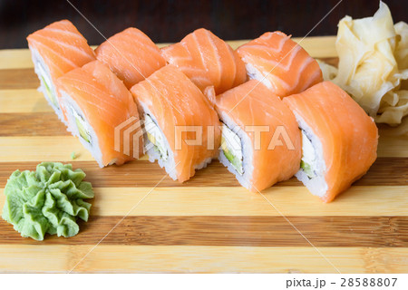 Philadelphia salmon sushi rolls on a wooden plate 28588807
