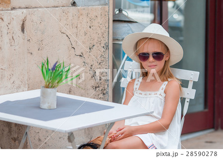 Little girl at outdoor cafe on warm summer day 28590278