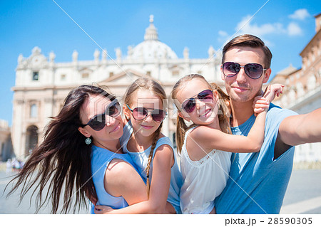 Happy young family taking selfie at St. Peter's Happy young family taking selfie at St. Peter's 28590305