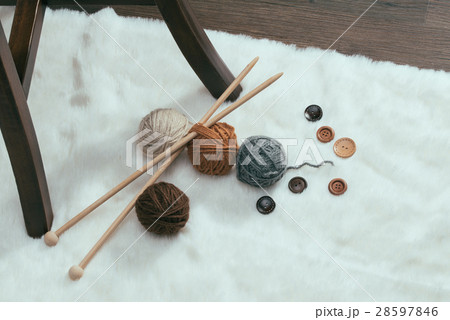 button and woolen yarn ball on carpet button and woolen yarn ball on carpet 28597846