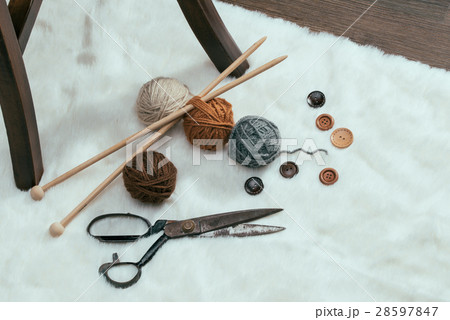 button, scissors and yarn ball on carpet button, scissors and yarn ball on carpet 28597847